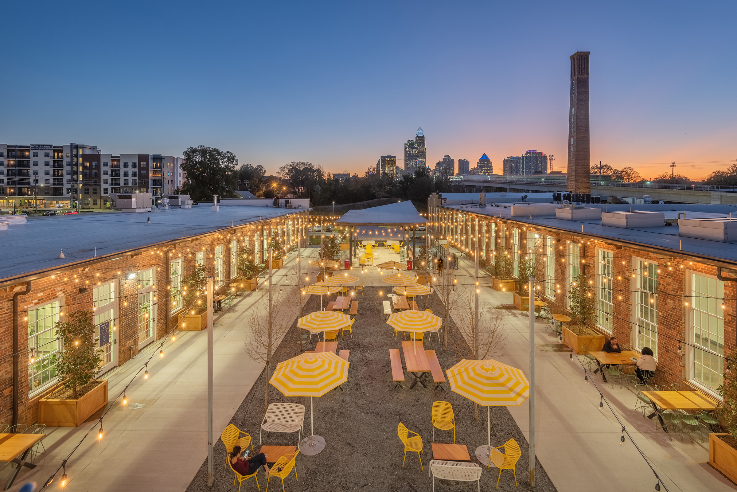 Optimist Hall Duke Energy Charlotte NC Exterior Twilight Eatery Center