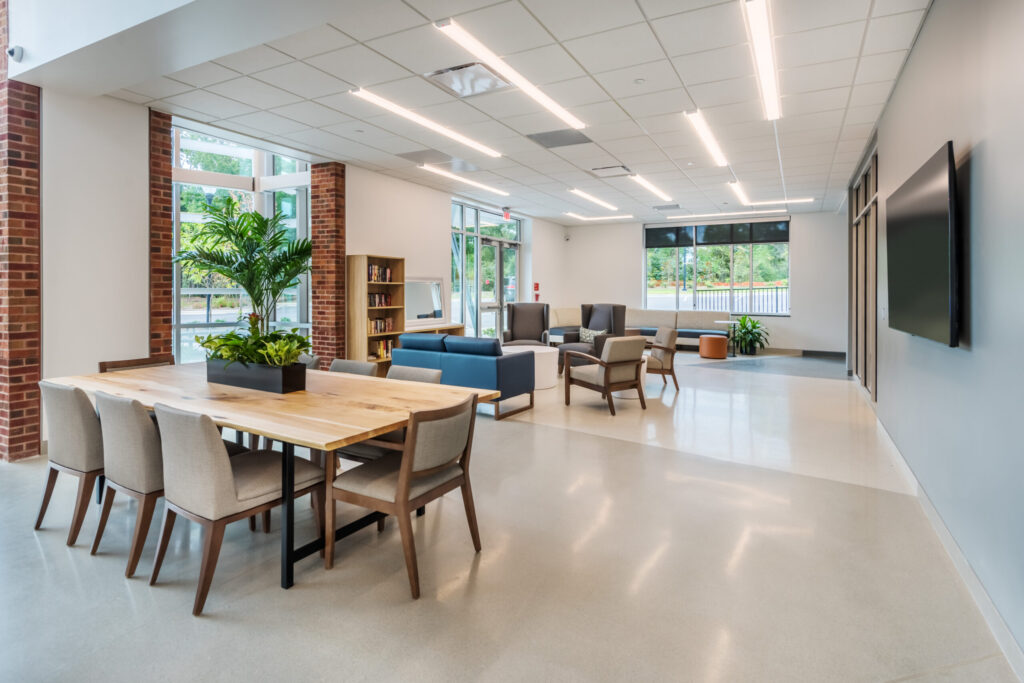 Apex Senior Center Activity Area with Seating, Tables, Books, and a TV