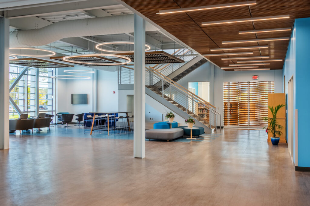 College of the Albemarle Dare County Campus Lobby with Tables, Chairs, Ottomans, and a Mounted TV