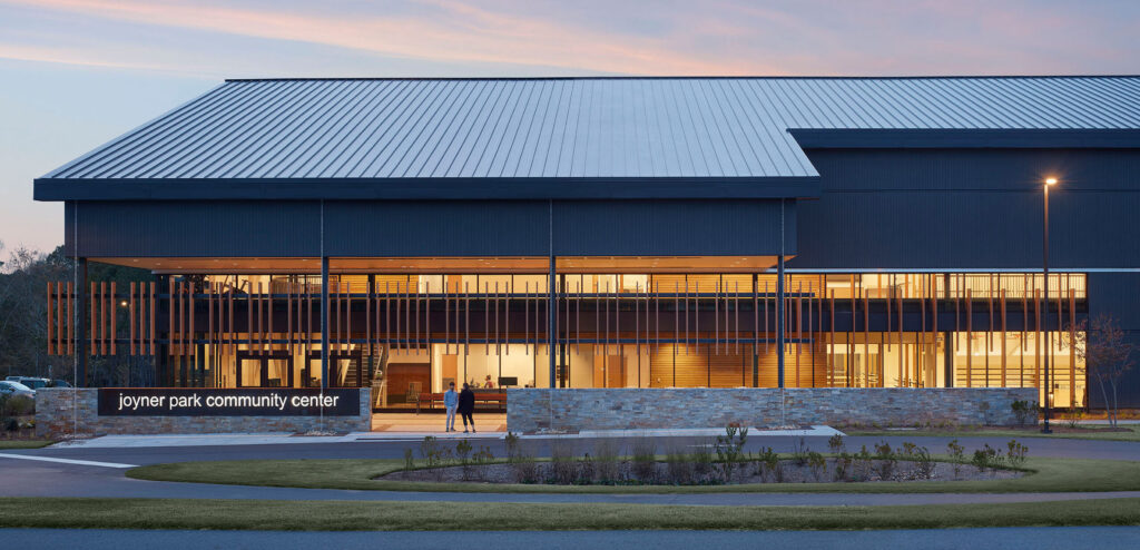 Joyner Park Community Center Exterior Front with Glowing Sign at Dusk