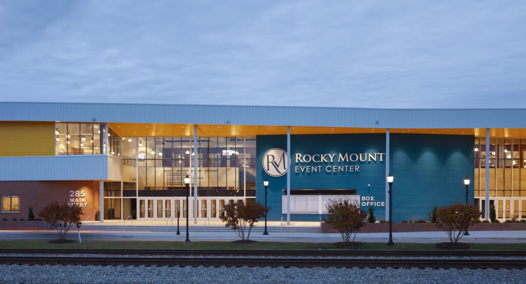 Rocky Mount Event Center Main Entrance with Lights at Dusk