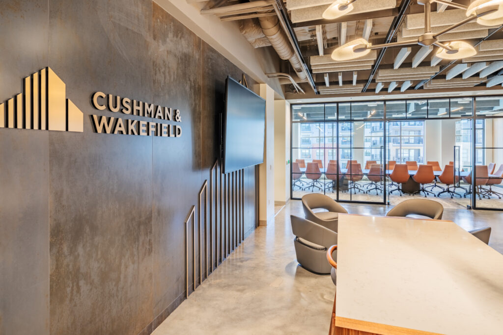 Lobby of Cushman & Wakefield with Name and TV on Wall