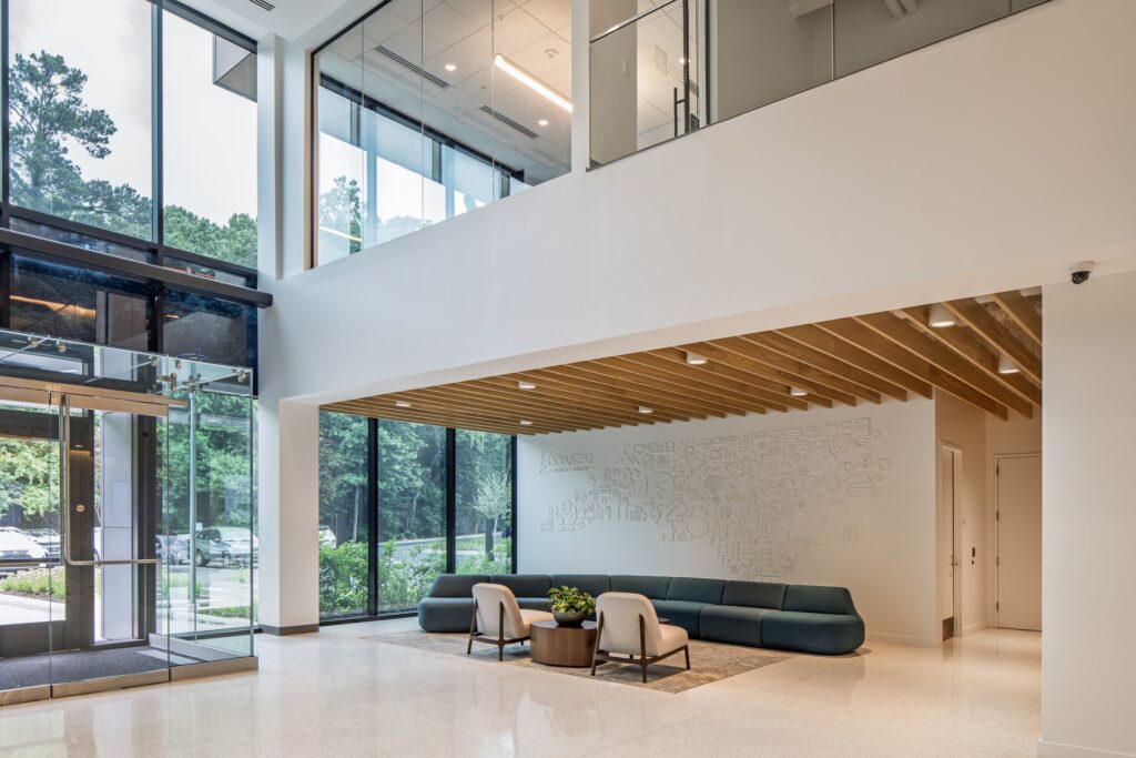 Glass entrance lobby at Coastal Credit Union headquarters renovation.