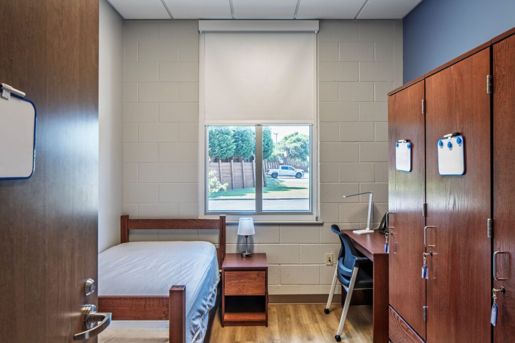 Bedroom with Bed, Desk, and Lockers